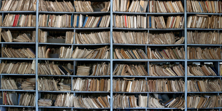 Shelves full of files in a messy old-fashioned archive